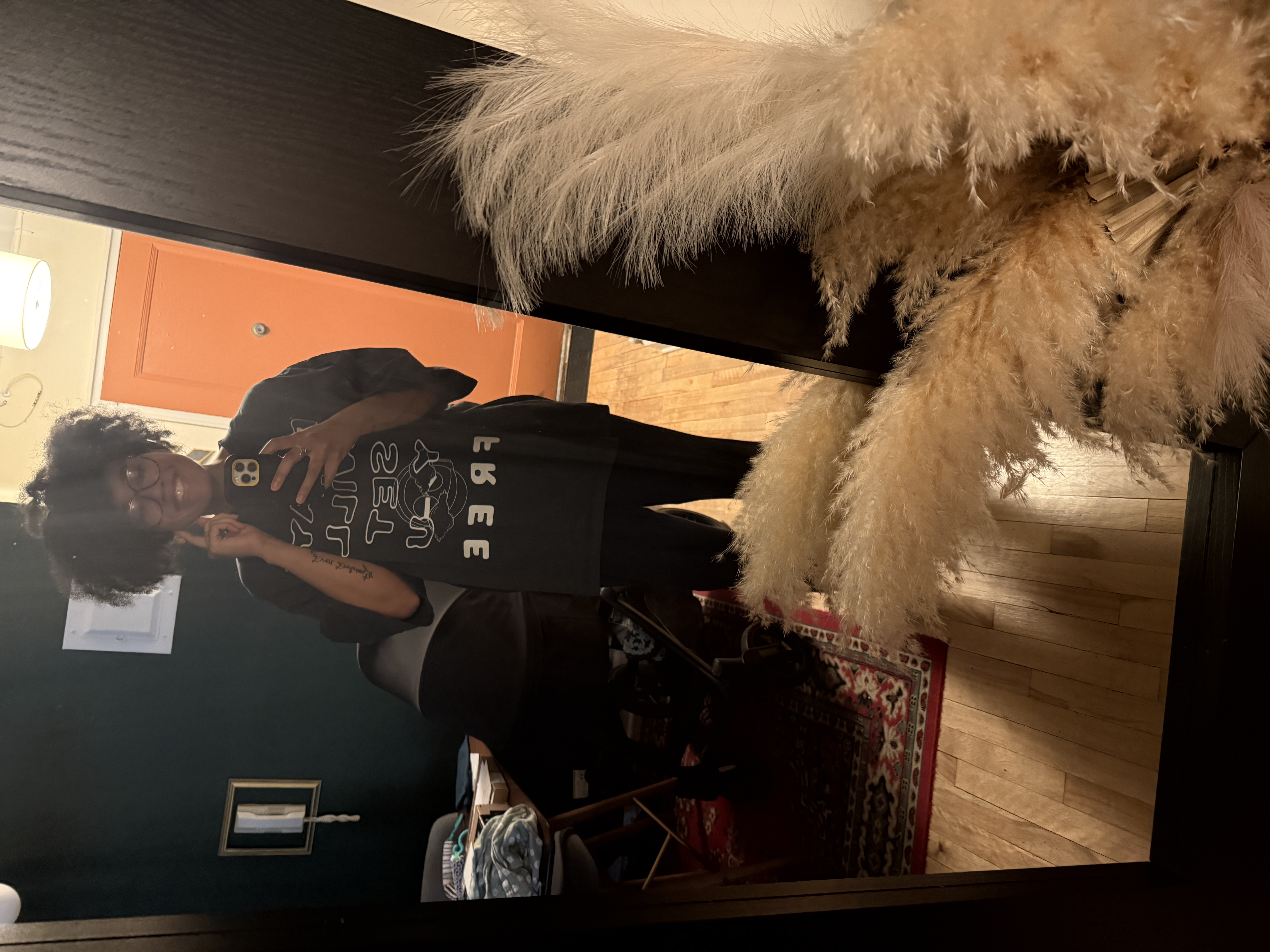 A fan wearing the PWSYF tee in the mirror