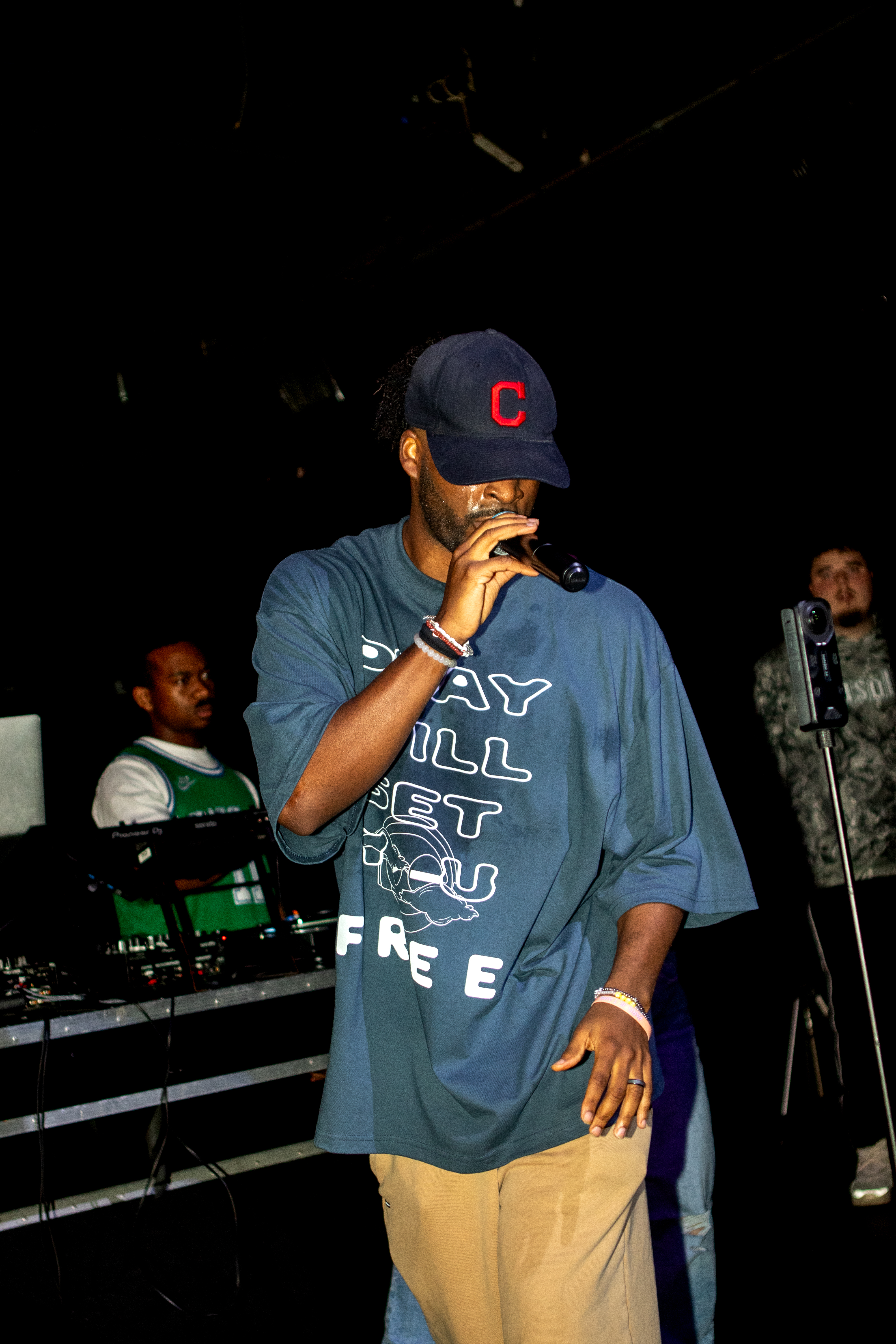 Ryan The Son on stage wearing the PWSYF tee, live in performance